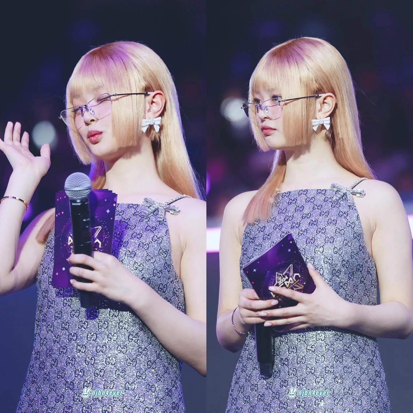 Nayeon on stage in lilac patterned dress