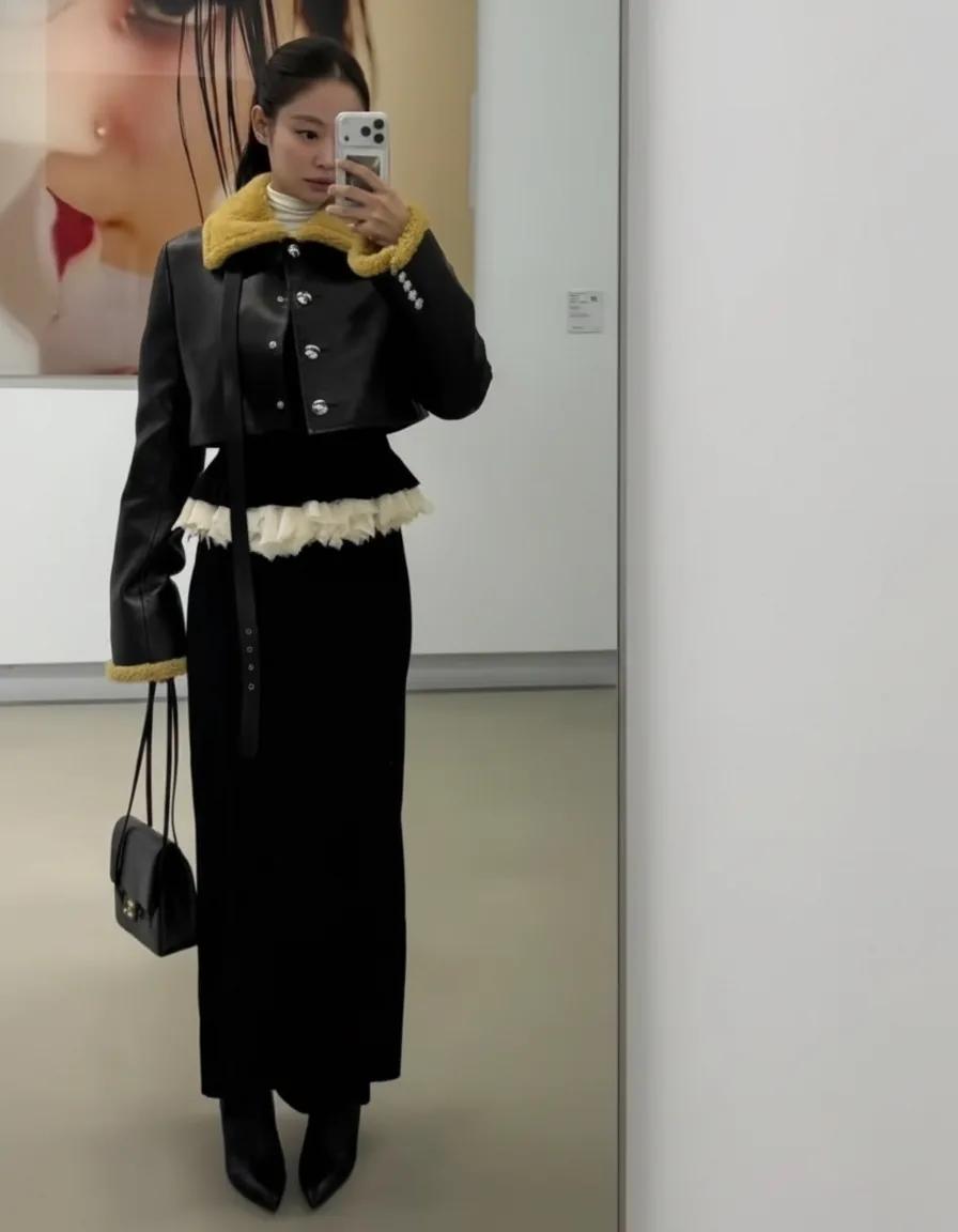 Jennie taking a selfie in a chic black outfit