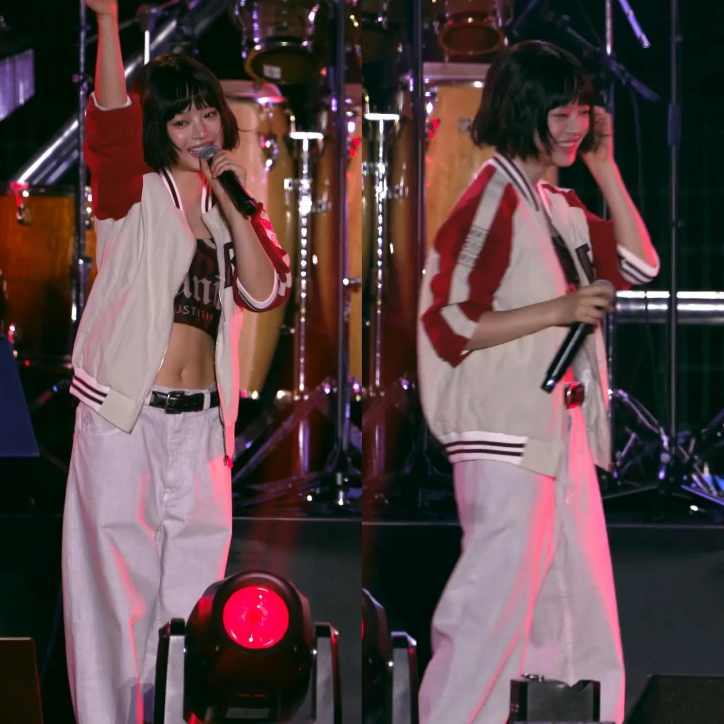 Lisa in oversized streetwear set at a stage event