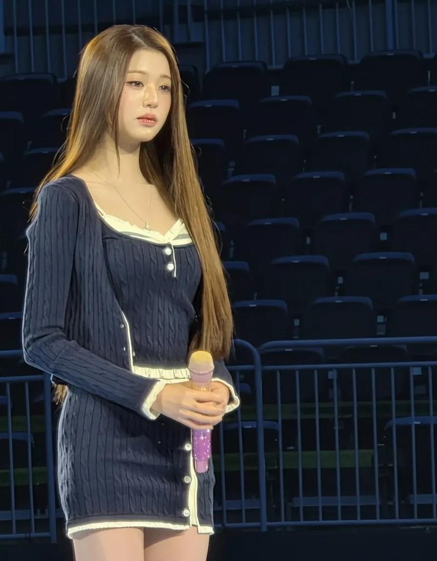 Jang Wonyoung on stage in a navy cable knit set