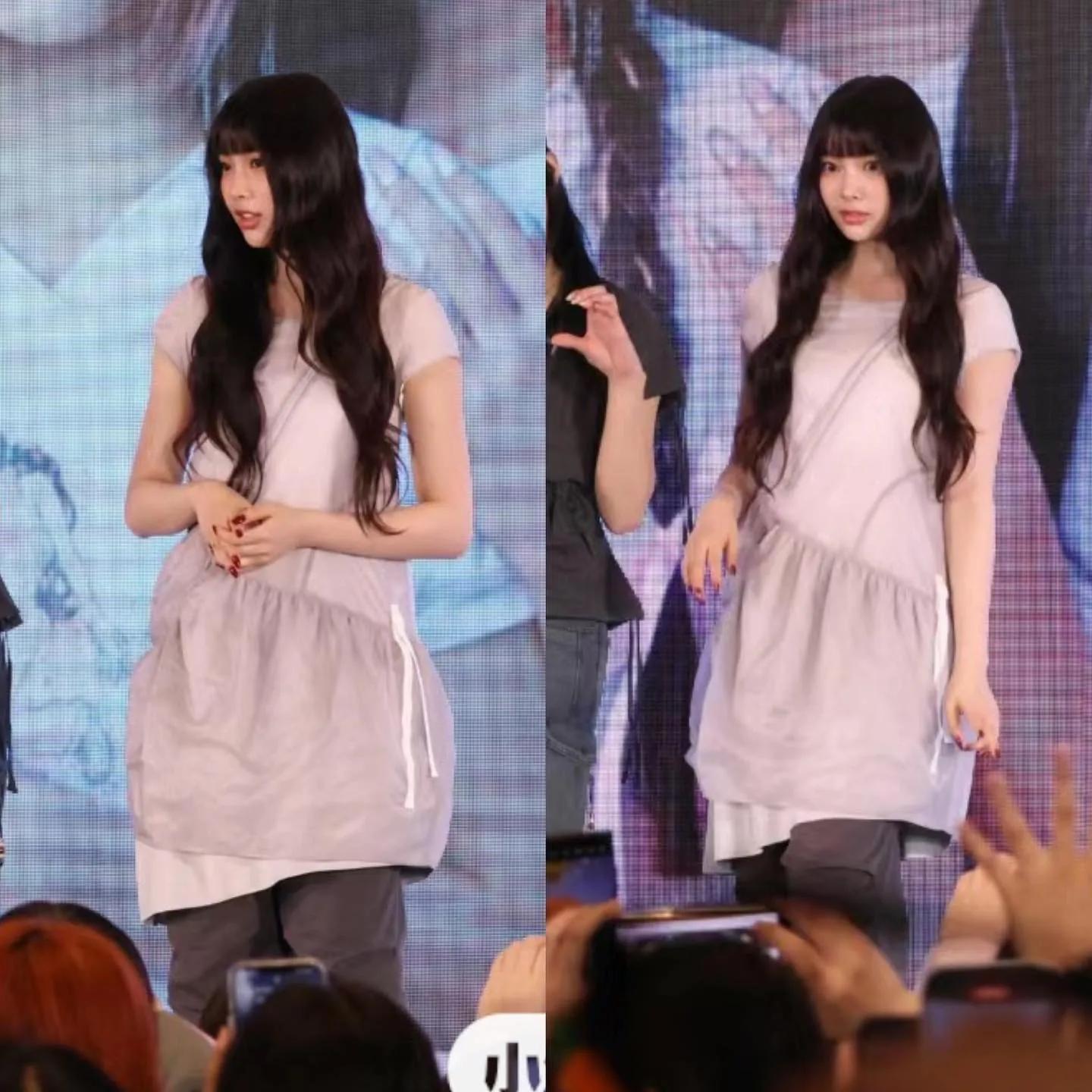 Lisa in a light pastel dress at an event